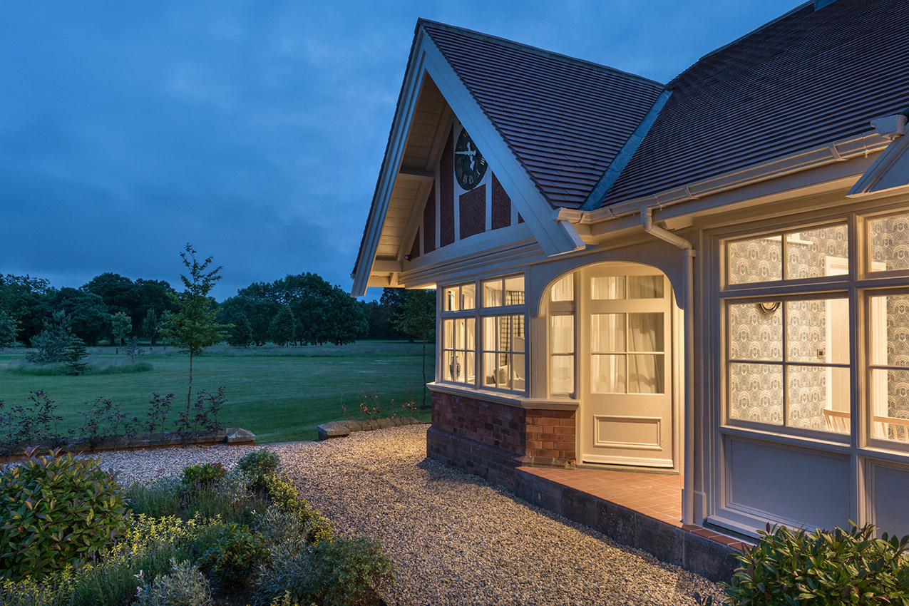 Exterior of a converted cricket pavillion at dusk
