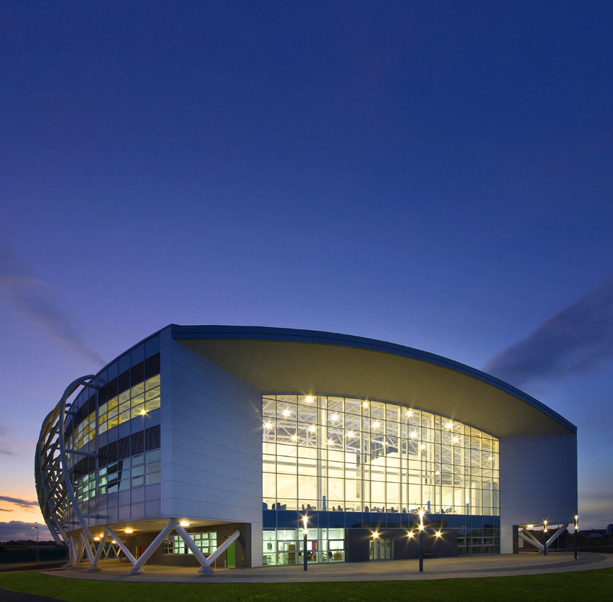 Architectural exterior of a school taken towards the main entrance at dusk