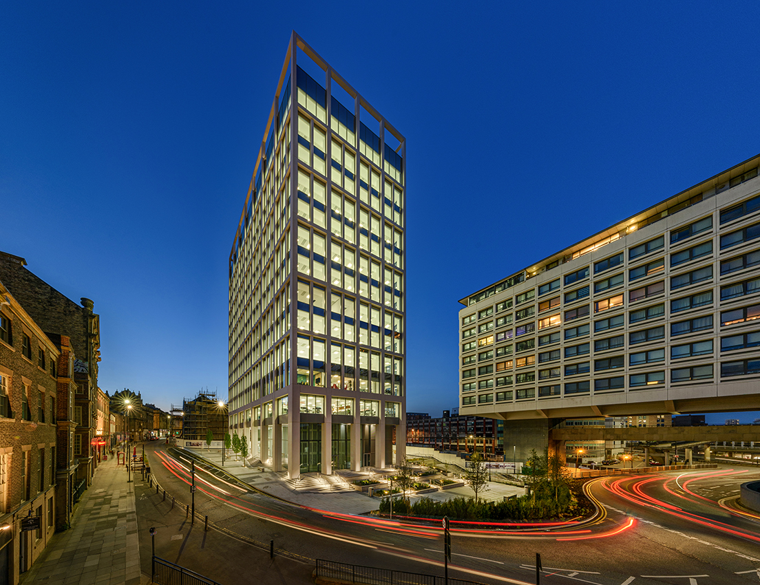 Commercial office building in Newcastle with traffic and streets at dusk
