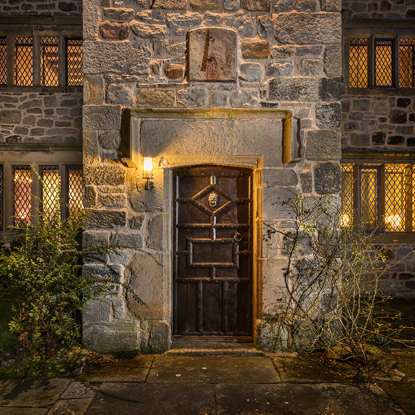 Detail of a wooden door at a period property at dusk
