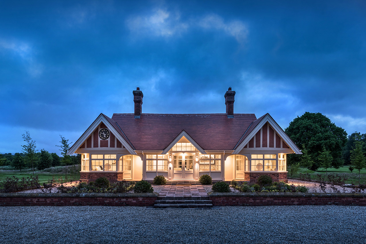 Exterior of a converted cricket pavillion at dusk