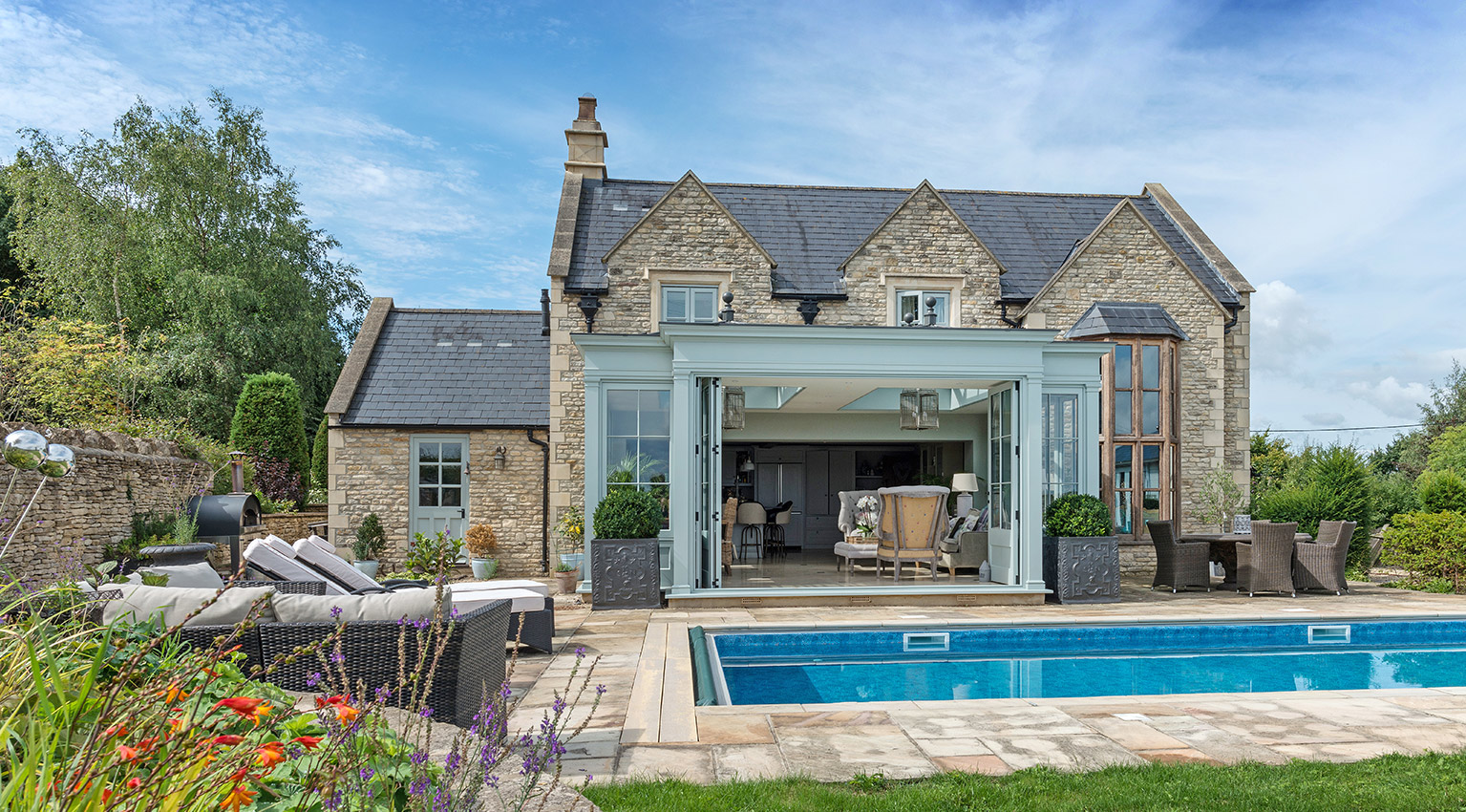 Orangery and outdoor pool in summer