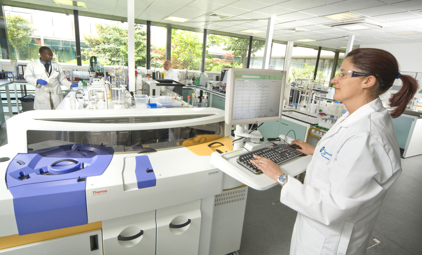 Workplace interior with person operating a scientific machine