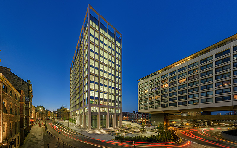 Architectural exterior of a commercial office building at dusk