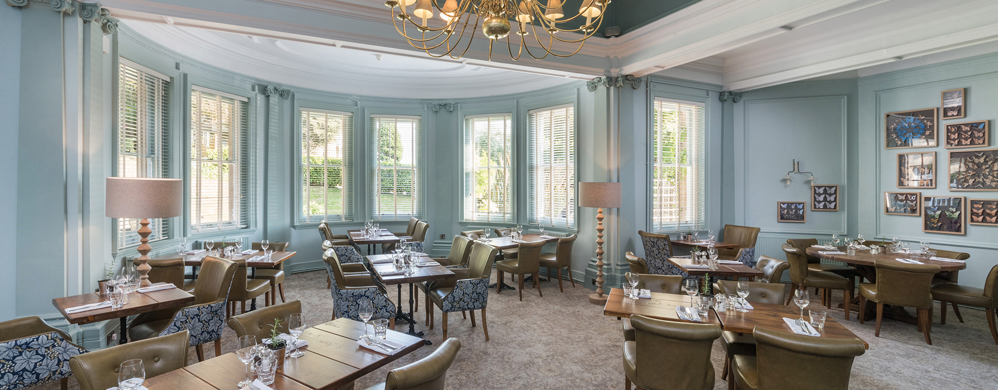 Interior view of a dining area in a hotel with wall art garden views and interior features