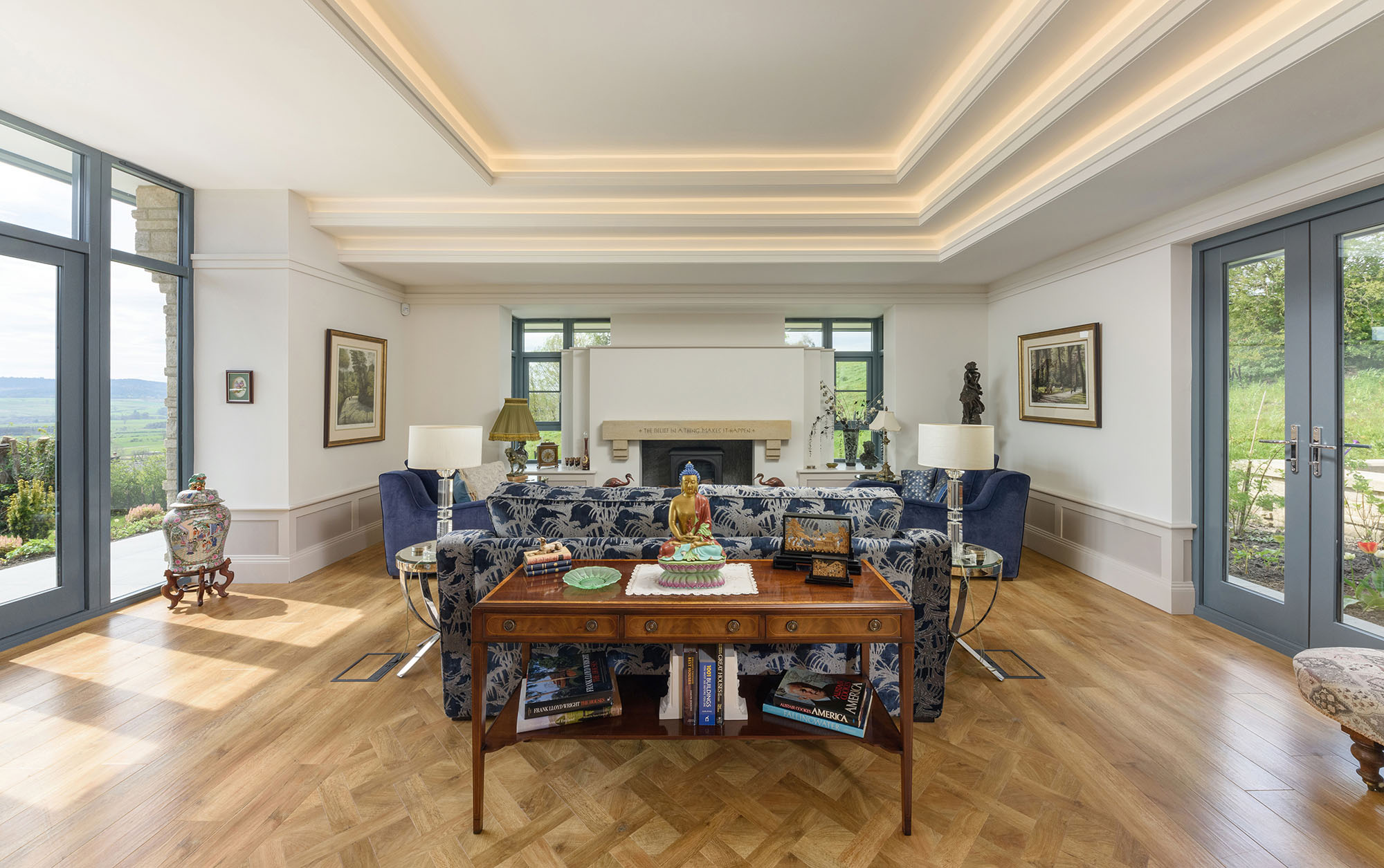 Interior of a property with wooden floors fireplace and views to the garden