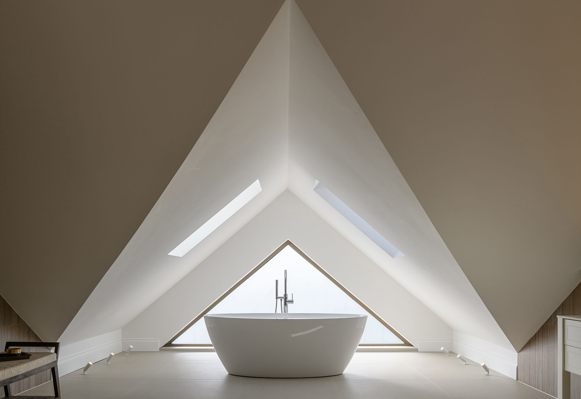 Interior design features of a bathroom with triangular window