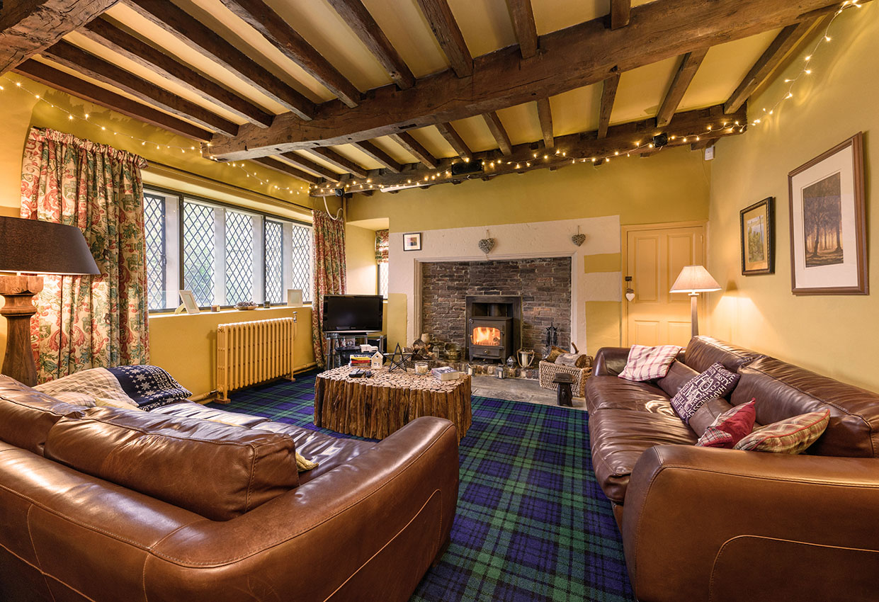 Residential interior with beams and fireplace